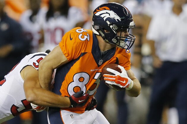 Denver Broncos wide receiver Wes Welker (83) his hit against the Houston Texans during the first half of an NFL preseason football game, Saturday, Aug. 23, 2014, in Denver. (AP Photo/Jack Dempsey)