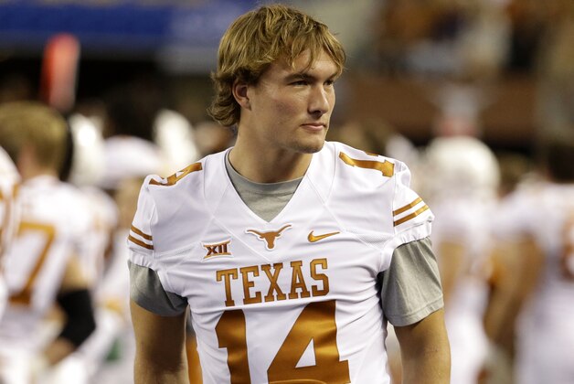 Texas quarterback David Ash walks along the sideline during an NCAA college football game against UCLA, Saturday, Sept. 13, 2014, in Arlington, Texas. (AP Photo/Tony Gutierrez)