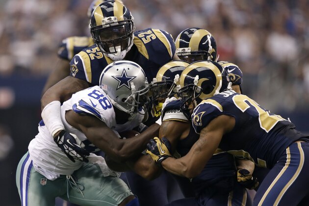 Dallas Cowboys wide receiver Dez Bryant (88) is gang tackled after making a reception by St. Louis Rams linebacker Alec Ogletree (52) and teammates during an NFL football game, Sunday, Sept. 22, 2013, in Arlington, Texas. The Cowboys won 31-7. (AP Photo/Tony Gutierrez)