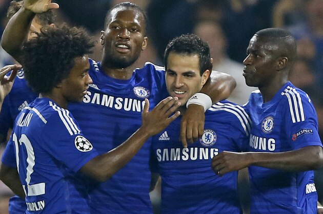 Chelsea celebrates the opening goal by  Cesc Fabregas, 2nd from right, during the Champions League Group G soccer match between Chelsea and Schalke 04 at Stamford Bridge stadium in London Wednesday, Sept. 17, 2014. (AP Photo/Kirsty Wigglesworth)
