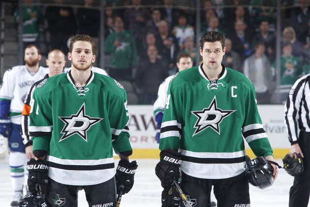DALLAS, TX - MARCH 6: Tyler Seguin #91 and Jamie Benn #14 of the Dallas Stars stand during the pre-game introductions against the Vancouver Canucks at the American Airlines Center on March 6, 2014 in Dallas, Texas. (Photo by Glenn James/NHLI via Getty Images)
