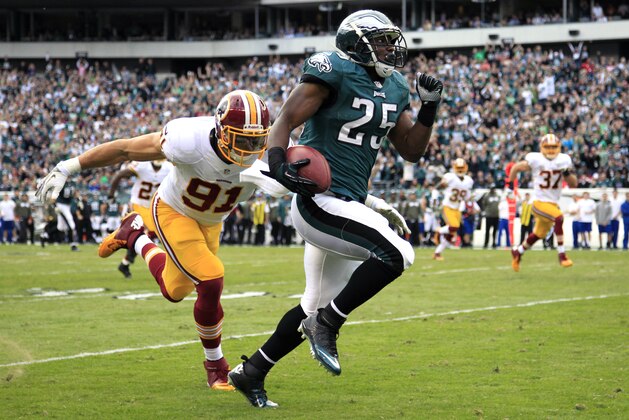 Washington Redskins outside linebacker Ryan Kerrigan (91) reaches for Philadelphia Eagles running back LeSean McCoy during the first half of an NFL football game in Philadelphia, Sunday, Nov. 17, 2013. (AP Photo/Matt Rourke)