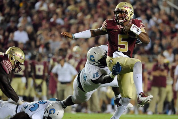 Sep 6, 2014; Tallahassee, FL, USA; Florida State Seminoles quarterback Jameis Winston (5) scrambles away from Citadel Bulldogs defensive lineman Mitchell Jeter (62) during the first half at Doak Campbell Stadium. Mandatory Credit: Melina Vastola-USA TODAY Sports