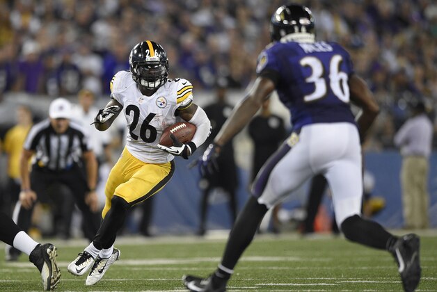 Pittsburgh Steelers running back Le'Veon Bell (26) carries the ball against Baltimore Ravens strong safety Jeromy Miles (36) during the second half of an NFL football game Thursday, Sept. 11, 2014, in Baltimore. (AP Photo/Nick Wass)