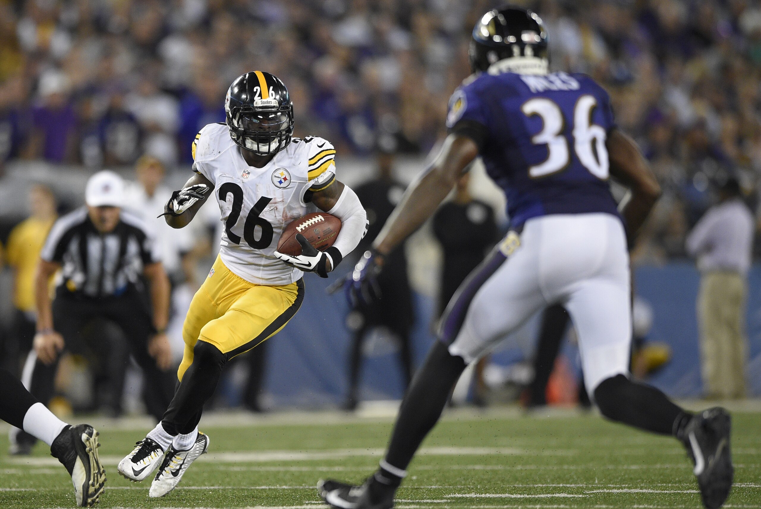 Pittsburgh Steelers running back Le'Veon Bell (26) carries the ball against Baltimore Ravens strong safety Jeromy Miles (36) during the second half of an NFL football game Thursday, Sept. 11, 2014, in Baltimore. (AP Photo/Nick Wass)
