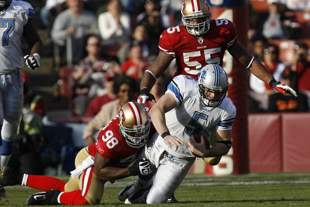 Detroit Lions quarterback Drew Stanton (5) is tackled by San Francisco 49ers linebacker Manny Lawson (99) in an NFL football game in San Francisco, Sunday, Dec. 27, 2009. (AP Photo/Tony Avelar)