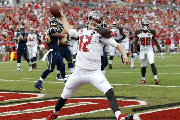 Tampa Bay Buccaneers quarterback Josh McCown (12) spikes the football after scoring on a 5-yard touchdown run against the St. Louis Rams during the first quarter of an NFL football game Sunday, Sept. 14, 2014, in Tampa, Fla. (AP Photo/Brian Blanco)