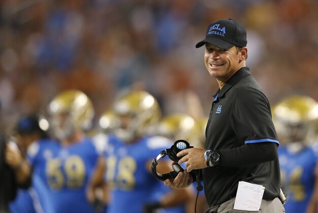 Sep 13, 2014; Arlington, TX, USA; UCLA Bruins head coach Jim Mora smiles on the sidelines against the Texas Longhorns at AT&T Stadium. The Bruins beat the Longhorns 20-17. Mandatory Credit: Matthew Emmons-USA TODAY Sports