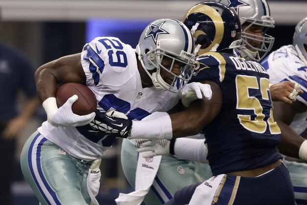 Dallas Cowboys running back DeMarco Murray (29) is wrapped up by St. Louis Rams' Alec Ogletree (52) during an NFL football game, Sunday, Sept. 22, 2013, in Arlington, Texas. The Cowboys won 31-7. (AP Photo/Tony Gutierrez)