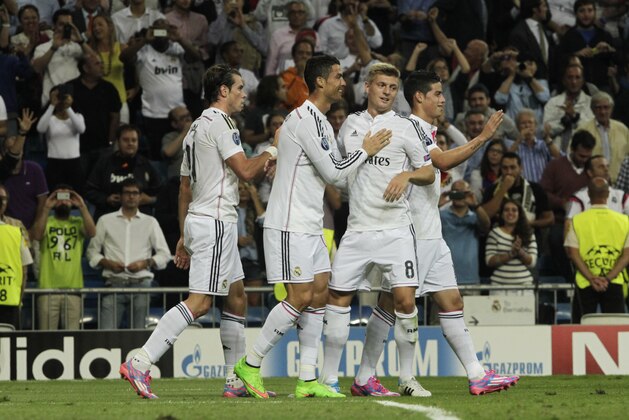 Real's Cristiano Ronaldo, 2nd left, celebrates his goal with teammates during a Champions League final Group B soccer match between Real Madrid and FC Basel at the Santiago Bernabeu stadium in Madrid, Spain, Tuesday, Sept. 16, 2014. (AP Photo/Gabriel Pecot)