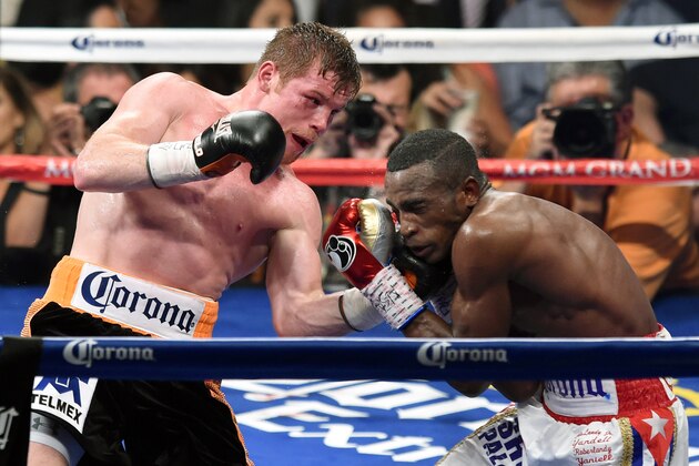 LAS VEGAS, NV - JULY 12:  Canelo Alvarez (L) hits Erislandy Lara in the seventh round of their junior middleweight bout at the MGM Grand Garden Arena on July 12, 2014 in Las Vegas, Nevada. Alvarez won in a split decision.  (Photo by Ethan Miller/Getty Images)