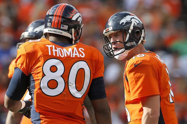 Denver Broncos quarterback Peyton Manning (18) yells to teammate Julius Thomas (80) during the second half of an NFL football game against the Kansas City Chiefs on Sunday, Sept. 14, 2014, in Denver. (AP Photo/Joe Mahoney)