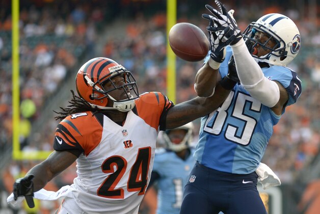 Cincinnati Bengals cornerback Adam Jones (24) breaks up a pass intended for Tennessee Titans wide receiver Nate Washington (85) in the first half of an NFL preseason football game, Saturday, Aug. 17, 2013, in Cincinnati. (AP Photo/Michael Keating)