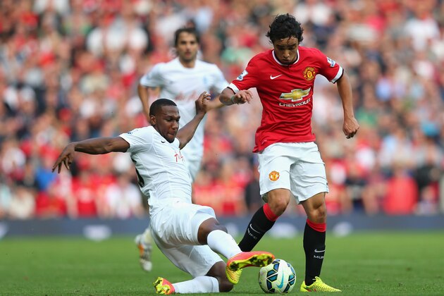 MANCHESTER, ENGLAND - SEPTEMBER 14:  Rafael of Manchester United is tackled by David Hoilett of QPR during the Barclays Premier League match between Manchester United and Queens Park Rangers at Old Trafford on September 14, 2014 in Manchester, England.  (Photo by Alex Livesey/Getty Images)