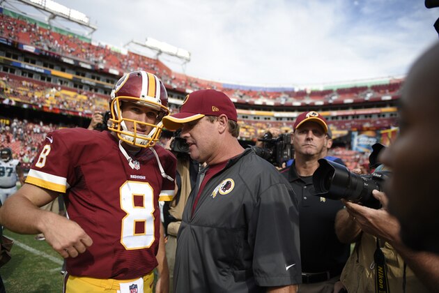 Washington Redskins quarterback Kirk Cousins (8) talks with head coach Jay Gruden, right, after an NFL football game Sunday, Sept. 14, 2014, in Landover, Md. The Redskins won 41-10. (AP Photo/Nick Wass)