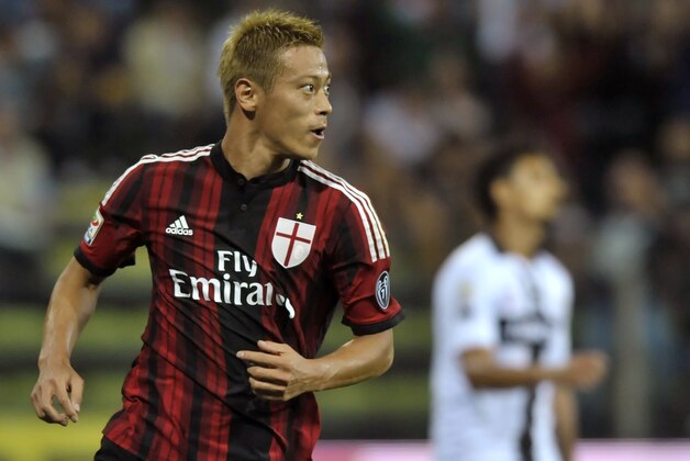 AC Milan's Keisuke Honda celebrates after scoring his side's second goal during a Serie A soccer match against Parma, at Parma's Tardini stadium, Italy, Sunday, Sept. 14, 2014. (AP Photo/Marco Vasini)