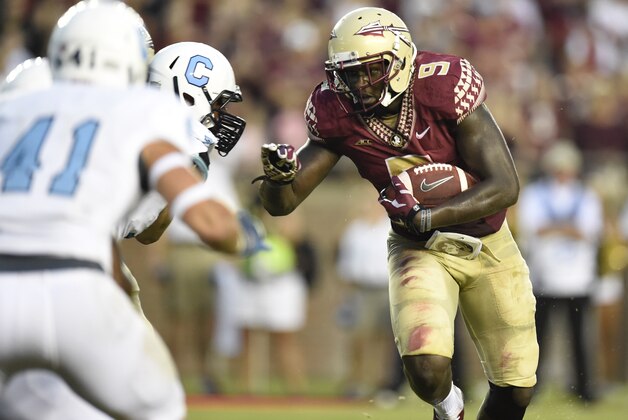 Sep 6, 2014; Tallahassee, FL, USA;  Florida State Seminoles running back Karlos Williams (9) carries up the field against the Citadel Bulldogs during the first quarter at Doak Campbell Stadium. Mandatory Credit: John David Mercer-USA TODAY Sports