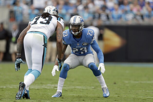 Detroit Lions' Darius Slay (23) looks to cover Carolina Panthers' Kelvin Benjamin (13) during the second half of an NFL football game in Charlotte, N.C., Sunday Sept. 14, 2014. The Panthers won 24-7. (AP Photo/Bob Leverone)