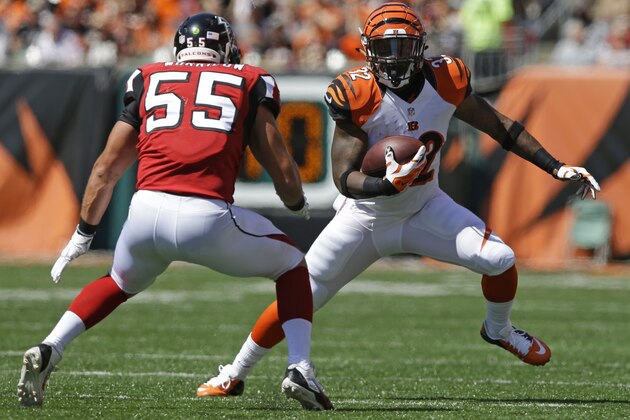 Cincinnati Bengals running back Jeremy Hill (32) runs against Atlanta Falcons inside linebacker Paul Worrilow (55) in the first half of an NFL football game, Sunday, Sept. 14, 2014, in Cincinnati. (AP Photo/Michael Conroy)