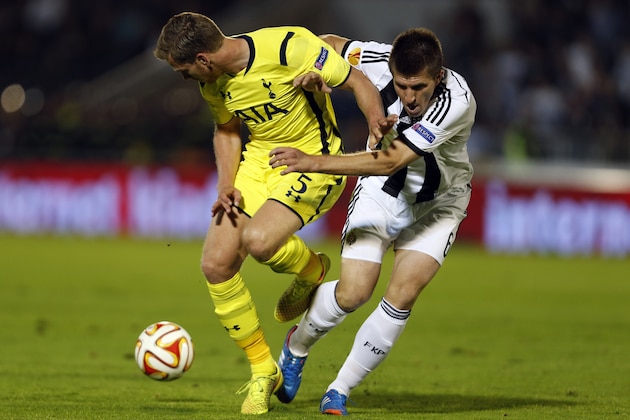 Tottenham Hotspur's Jan Vertonghen, left, is challenged by Partizan Belgrade's Vojislav Stankovic during the Europa League Group C soccer match between Partizan Belgrade and Tottenham Hotspur in Belgrade, Serbia, Thursday, Sept. 18, 2014. (AP Photo/Marko Drobnjakovic)