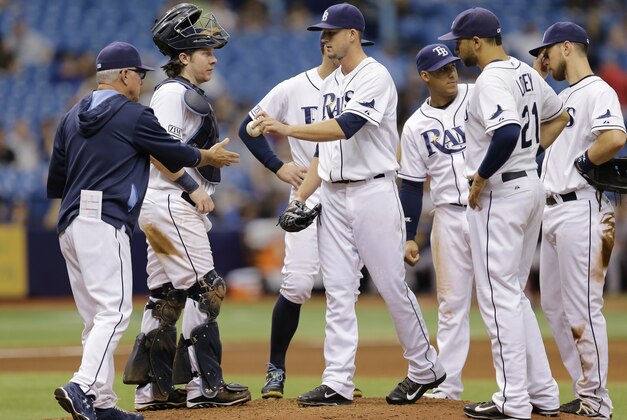 Tampa Bay Rays starting pitcher Drew Smyly, center, hands the ball to manager Joe Maddon, left, after eating taken out of the game against the Boston Red Sox during the sixth inning of a baseball game Monday, Sept. 1, 2014, in St. Petersburg, Fla. (AP Photo/Chris O'Meara)