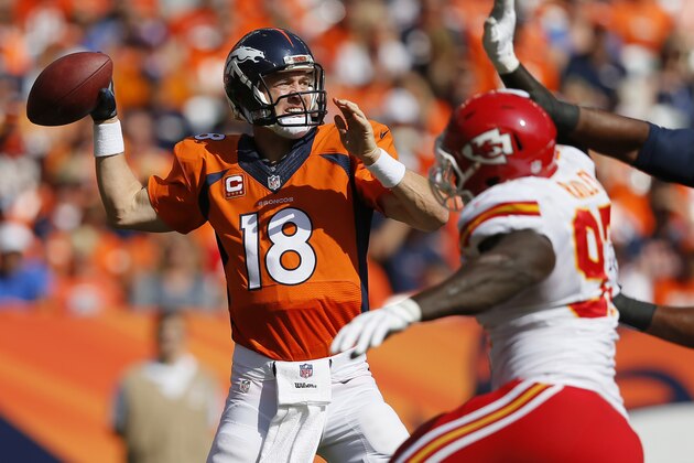 Denver Broncos quarterback Peyton Manning (18) throws under pressure from Kansas City Chiefs defensive end Allen Bailey during the first half of an NFL football game, Sunday, Sept. 14, 2014, in Denver. (AP Photo/Jack Dempsey)