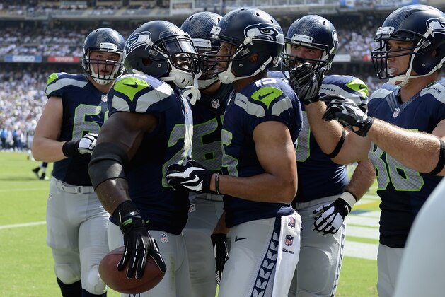 SAN DIEGO, CA - SEPTEMBER 14:  Running back Robert Turbin #22 of the Seattle Seahawks is congratulated by teammates after scoring a touchdown against the San Diego Chargers at Qualcomm Stadium on September 14, 2014 in San Diego, California.  (Photo by Harry How/Getty Images)
