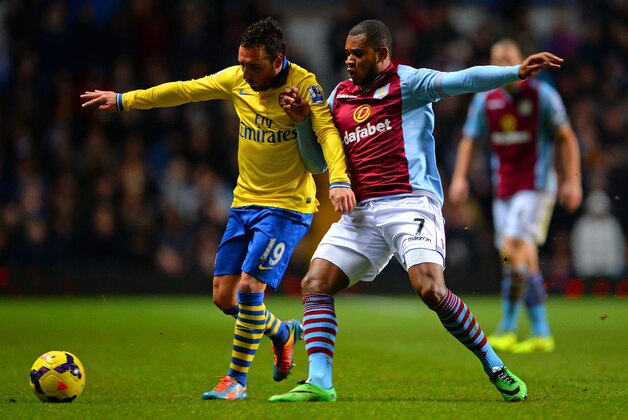 BIRMINGHAM, ENGLAND - JANUARY 13:  Santi Cazorla of Arsenal is marshalled by Leandro Bacuna of Aston Villa during the Barclays Premier League match between Aston Villa and Arsenal at Villa Park on January 13, 2014 in Birmingham, England.  (Photo by Michael Regan/Getty Images)