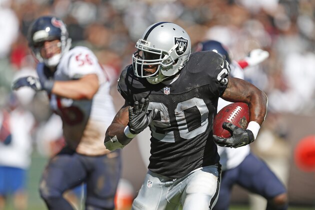 Oakland Raiders running back Darren McFadden carries the ball on a touchdown run in the fourth quarter of an NFL football game against the Houston Texans Sunday, Sept. 14, 2014, in Oakland, Calif. (AP Photo/Beck Diefenbach)
