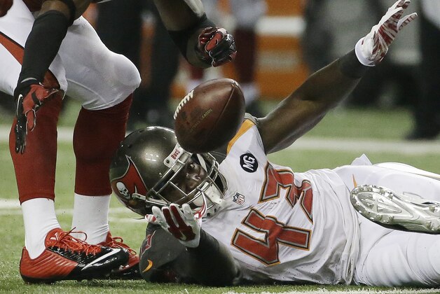 Tampa Bay Buccaneers running back Bobby Rainey (43) loses the ball as Atlanta Falcons free safety Dwight Lowery (20) prepares to recover it during the first half of an NFL football game, Thursday, Sept. 18, 2014, in Atlanta. (AP Photo/David Goldman)