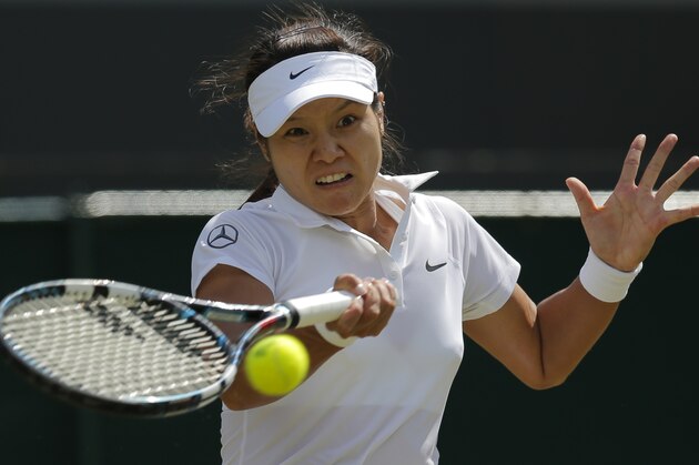 Li Na of China returns to Barbora Zahlavova Strycova of the Czech Republic during their women's singles match at the All England Lawn Tennis Championships in Wimbledon, London, Friday  June  27, 2014. (AP Photo/Pavel Golovkin)