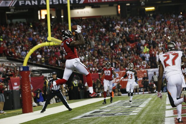 Atlanta Falcons wide receiver Julio Jones (11) makes a touch-down catch against the Tampa Bay Buccaneers during the first half of an NFL football game, Thursday, Sept. 18, 2014, in Atlanta. (AP Photo/John Bazemore)
