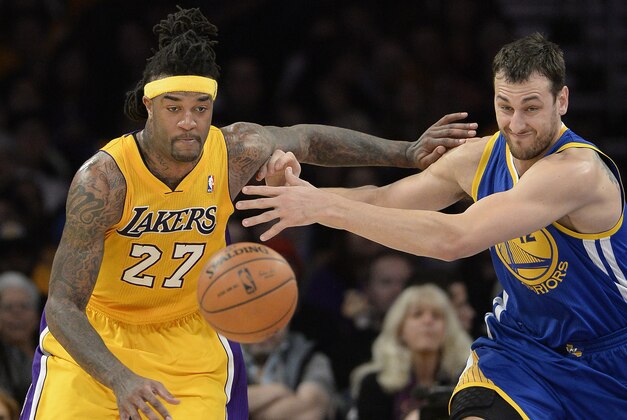 Apr 11, 2014; Los Angeles, CA, USA; Los Angeles Lakers forward Jordan Hill (27) and Golden State Warriors center Andrew Bogut (12) chase a loose ball at Staples Center. Mandatory Credit: Richard Mackson-USA TODAY Sports