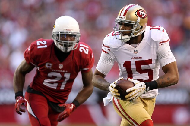 GLENDALE, AZ - DECEMBER 29:   Michael Crabtree #15 of the San Francisco 49ers catches a 14 yard pass by Colin Kaepernick #7 in the second quarter against Patrick Peterson #21 of the Arizona Cardinals during a game at University of Phoenix Stadium on December 29, 2013 in Glendale, Arizona.  (Photo by Christian Petersen/Getty Images)