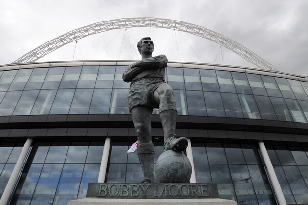 A statue of Sir Bobby Moore stands in front of Wembley Stadium, London, Tuesday Aug. 9, 2011.  Raging riots across London forced England to call off Wednesday's soccer match against the Netherlands at Wembley Stadium.  The Football Association made the decision Tuesday morning after talks with the British government and the Metropolitan Police, who had struggled to contain a third night of unrest in the British capital.  (AP Photo/Tom Hevezi)