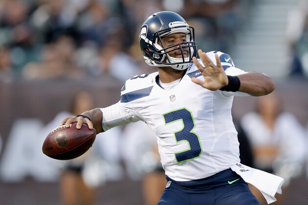 OAKLAND, CA - AUGUST 28: Quarterback Russell Wilson #3 of the Seattle Seahawks passes the ball against the Oakland Raiders during a preseason game at O.co Coliseum on August 28, 2014 in Oakland, California.  (Photo by Ezra Shaw/Getty Images)
