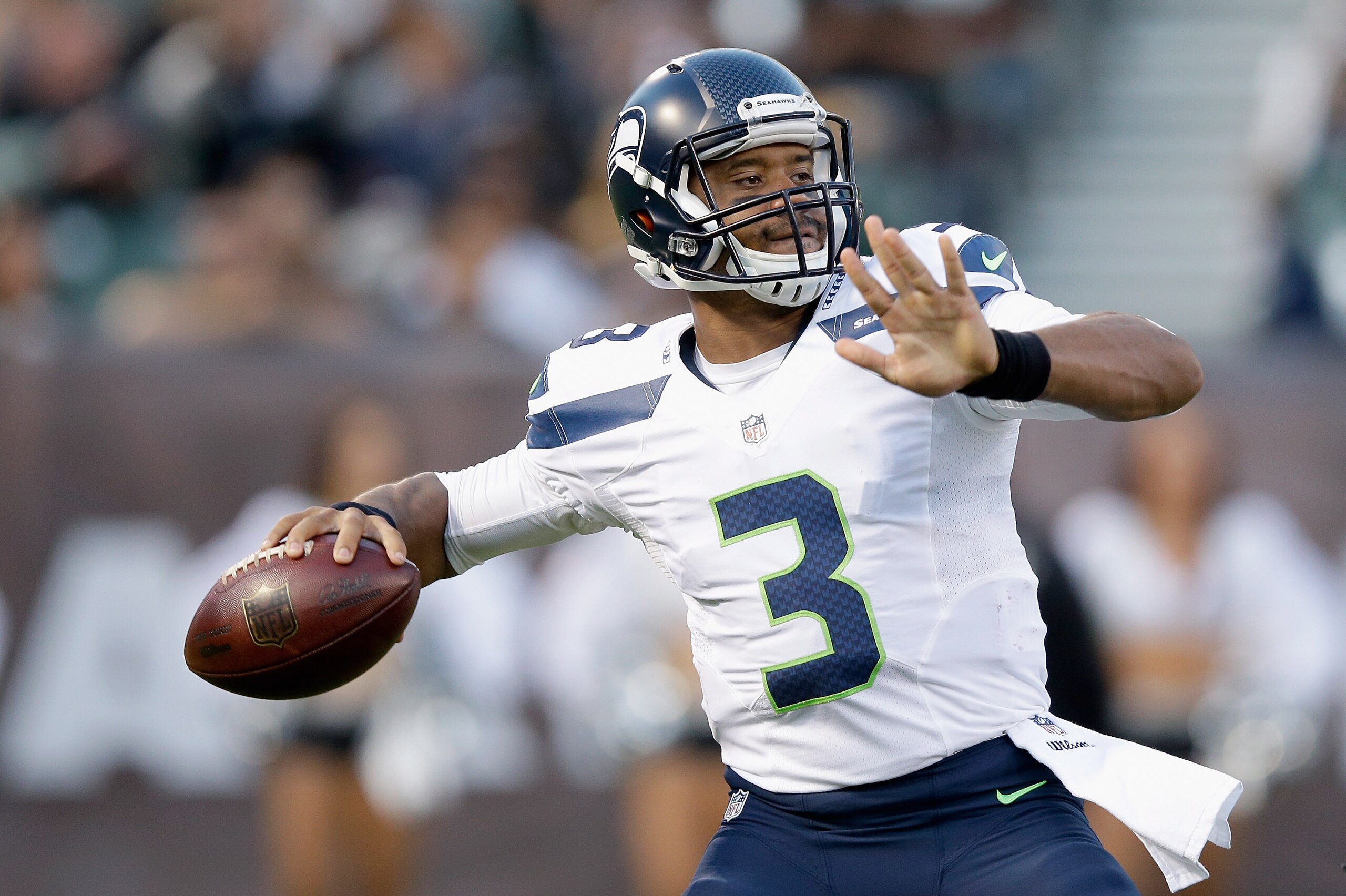OAKLAND, CA - AUGUST 28: Quarterback Russell Wilson #3 of the Seattle Seahawks passes the ball against the Oakland Raiders during a preseason game at O.co Coliseum on August 28, 2014 in Oakland, California.  (Photo by Ezra Shaw/Getty Images)