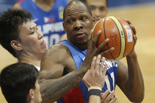 The Philippines Marcus Douthit, right, is double-teamed by Hong Kong's Wong Chun Wai, top left, and Lam Man Chun, left bottom, in the FIBA Asia Basketball Championship game Wednesday Aug.7, 2013 at the Mall of Asia Arena at suburban Pasay city south of Manila, Philippines. The Philippines won 67-55. (AP Photo/Bullit Marquez)