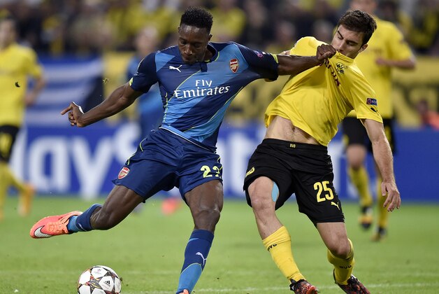 Arsenal's Danny Welbeck, left, is challenged by Dortmund's Sokratis, right, during the Champions League group D soccer match between Borussia Dortmund and Arsenal in Dortmund, Germany, Tuesday, Sept.16, 2014. (AP Photo/Martin Meissner)