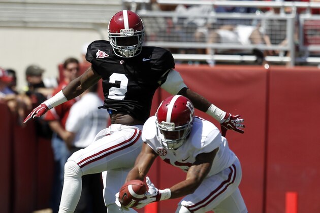 Wide receiver ArDarius Stewart (13) catches a deflected pass over defensive back Tony Brown (2) during Alabama's A-Day NCAA college football spring game on Saturday, April 19, 2014, in Tuscaloosa, Ala. (AP Photo/Butch Dill)