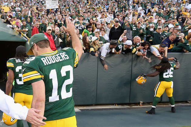 GREEN BAY, WI - SEPTEMBER 14:  Quarterback Aaron Rodgers #12 of the Green Bay Packers waves to fans as he walks off the field following the NFL game against the New York Jets at Lambeau Field on September 14, 2014 in Green Bay, Wisconsin. The Packers defeated the Jets 31-24.  (Photo by Christian Petersen/Getty Images)