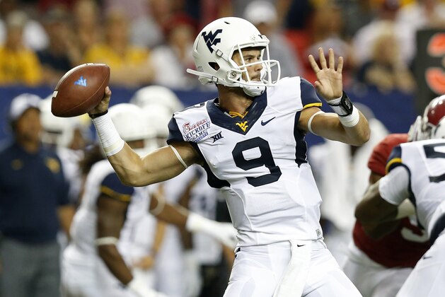 West Virginia quarterback Clint Trickett (9) throws a pass in the second half of an NCAA college football game against the Alabama Saturday, Aug. 30, 2014, in Atlanta. (AP Photo/Brynn Anderson)