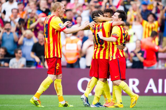 BARCELONA, SPAIN - SEPTEMBER 13: Neymar Santos Jr (2nd R) of FC Barcelona is congratulated by his teammates Jeremy Mathieu (L), Jordi Alba (C) and Lionel Messi (R) after scoring the opening goal during the La Liga match between FC Barcelona and Athletic Club at Camp Nou on September 13, 2014 in Barcelona, Spain. (Photo by Alex Caparros/Getty Images)