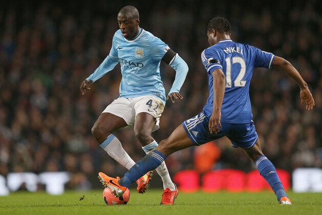 MANCHESTER, ENGLAND - FEBRUARY 15:  Yaya Toure of Manchester City attempts to move past a challenge from  John Obi Mikel of Chelsea during the FA Cup Fifth Round match sponsored by Budweiser between Manchester City and Chelsea at Etihad Stadium on February 15, 2014 in Manchester, England.  (Photo by Clive Brunskill/Getty Images)