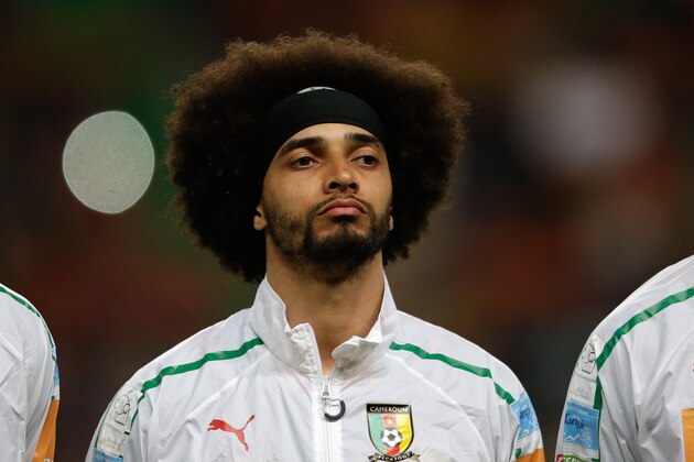 Cameroon's Benoit Assou Ekotto listens to the national anthems before their friendly soccer match with Portugal Wednesday, March 5 2014, in Leiria, Portugal. The game is part of both teams' preparation for the World Cup in Brazil. (AP Photo/Armando Franca)