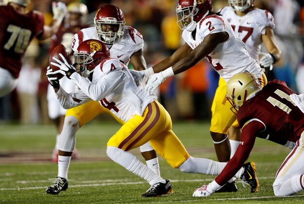 Sep 13, 2014; Boston, MA, USA; Southern California Trojans cornerback Chris Hawkins (4) reacts after making an interception during the second quarter against the Boston College Eagles at Alumni Stadium. Mandatory Credit: Greg M. Cooper-USA TODAY Sports