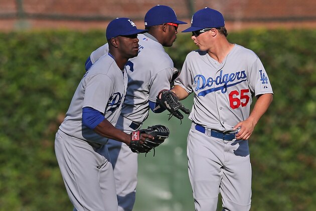 CHICAGO, IL - SEPTEMBER 19: (L-R) Roger Bernadina #18, Yasiel Puig #66 and Joc Pederson #65 of the Los Angeles Dodgers celebrate a win over the Chicago Cubs at Wrigley Field on September 19, 2014 in Chicago, Illinois. The Dodgers defeated the Cubs 14-5. (Photo by Jonathan Daniel/Getty Images)
