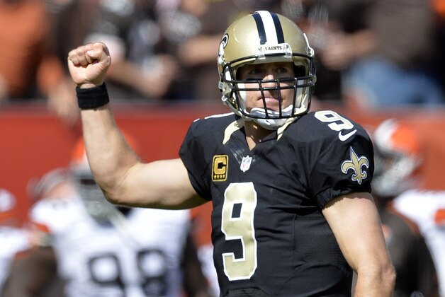 New Orleans Saints quarterback Drew Brees (9) celebrates after a touchdown pass to tight end Jimmy Graham in the third quarter of an NFL football game against the Cleveland Browns Sunday, Sept. 14, 2014, in Cleveland. (AP Photo/David Richard)