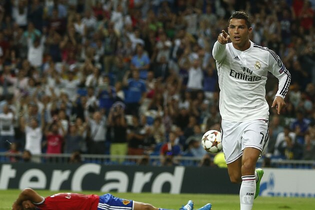 Real Madrid's Cristiano Ronaldo scores his side's third goal during the Champions League Group B soccer match between Real Madrid and Basel at the Santiago Bernabeu stadium in Madrid, Spain, Tuesday Sept. 16, 2014. (AP Photo/Andres Kudacki)