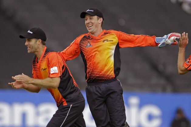 Delhi Daredevils Virender Sehwag, unseen, looses his wicket as Perth Scorchers Simon Katich, left, celebrates during a Champions League Twenty20  game in Cape Town, South Africa, Sunday, Oct 21, 2012. (AP Photo/Schalk van Zuydam)